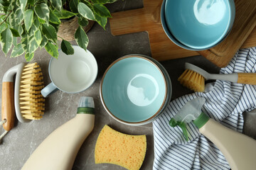 Concept of dish washing on gray textured table