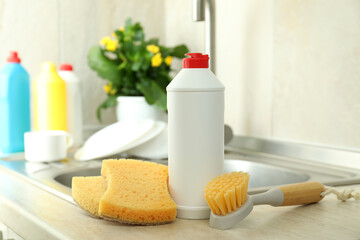 Concept of Dishwashing detergent accessories on kitchen background