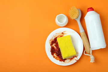 Concept of Dishwashing detergent accessories on orange background