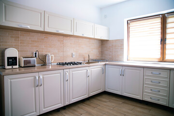 Cozy bright kitchen interior with wooden furniture