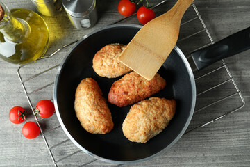 Concept of tasty food with cutlets on gray textured table