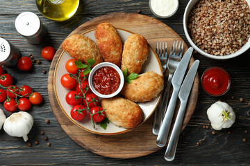 Concept of tasty food with cutlets on wooden table
