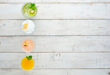 Set of classic cocktails on white wooden background with copy space. Top view or flat lay.