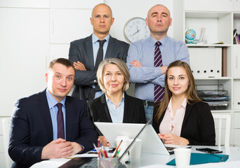 Portrait of confident professional business team of five in office interior