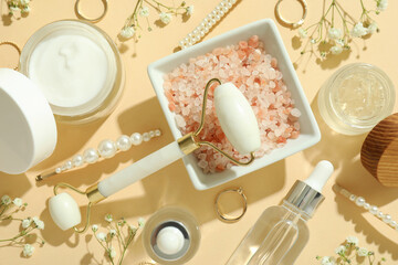 Skin care beauty concept with face roller on beige background