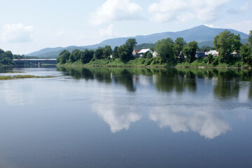 Obraz premium Reflection on the Connecticut River in Windsor Vt.