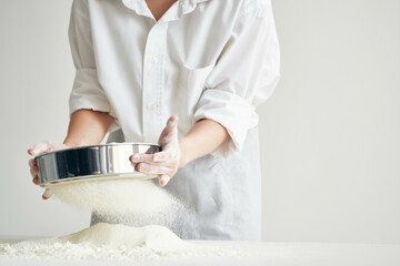 woman baker working with dough in the kitchen cooking pastry