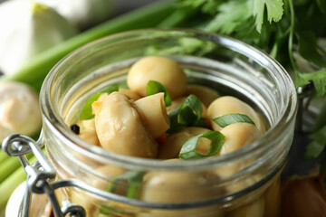 Glass jar of marinated mushrooms, close up