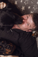High angle view of a man with dogs on the bed.