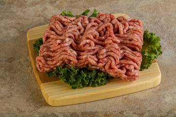 Raw pork minced meat over board