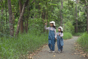 Children are heading to the family campsite in the forest Walk along the tourist route. Camping road. Family travel vacation concept.