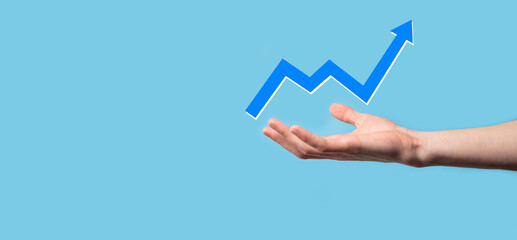 Hand hold drawing on screen growing graph, arrow of positive growth icon.pointing at creative business chart with upward arrows.Financial, business growth concept.
