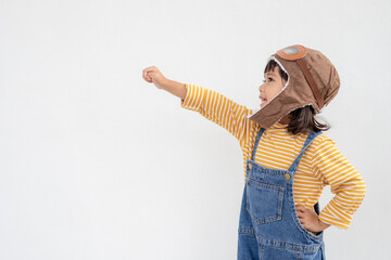 dreams of flight! little child girl playing with a pilot hat on white background © FAMILY STOCK
