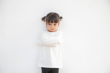 Angry little girl over white background, sign and gesture concept - obrazy, fototapety, plakaty