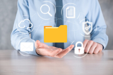 Document Management System DMS .Businessman hold folder and document icon.Software for archiving, searching and managing corporate files and information.Internet Technology Concept.Digital security