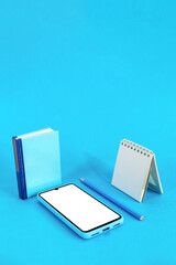 Obraz na płótnie Canvas Book, pencil, notebook and smart phone on blue background. Education concept. Digital Online Education.