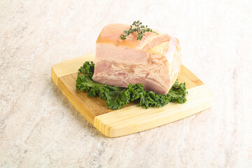 Cut of pork bacon over board