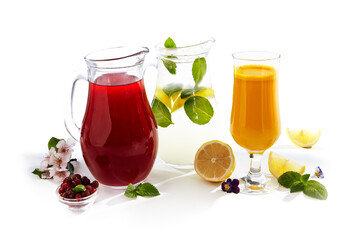 Berry and Lemon Summer Drink with Fresh Orange Juice on White Background. Freshness Lemonade Jar with ingredients on white table.