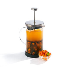 Tea in French Press on White Background. Homemade Tea with Berry and Green Herbs. Isolated over White.