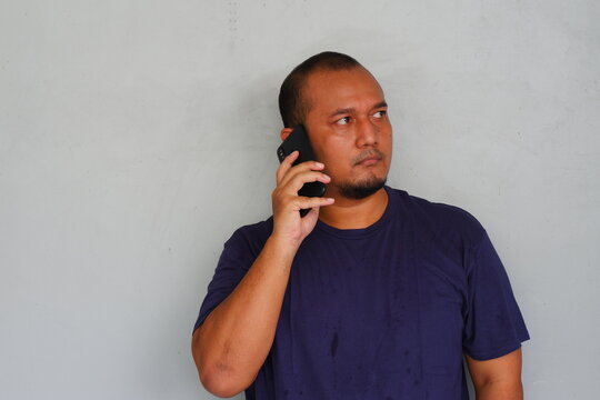 Young asian man make a phone call using smartphone