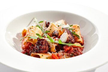 Cannelloni pasta with seafood and Parmesan cheese. Lasagna cannelloni pasta stuffed with tomato sauce and fried octopus. Italian pasta in white plate isolated on white background .