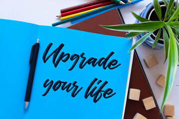 Upgrade Your Life, the phrase is written on multi-colored stickers, on a blue background. Business...