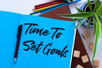 Time To Set Goals, the phrase is written on multi-colored stickers, on a blue background. Business concept, strategy, plan, planning.