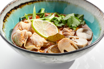 Tom yum or tom yam - hot and sour Thai soup with chicken. Thai traditional soup with chicken and...