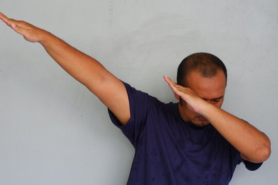 Young asian man with dab gesture