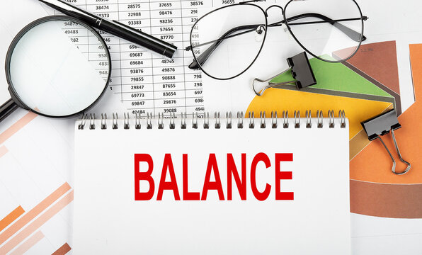 Text BALANCE on white paper notebook on the diagram. Business concept