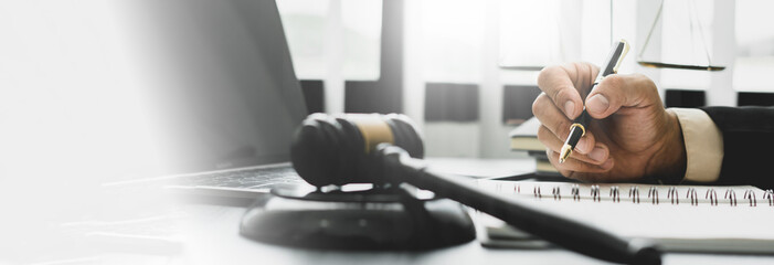 Legal counsel presents to the client a signed contract with gavel and legal law. justice and lawyer...