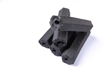activated carbon of macadamia shell charcoal briquettes isolated on white background