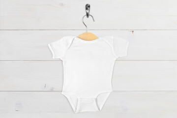 White Onesie Mockup on Wood Hanger