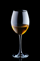 Glass with white wine isolated on black