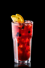 Cold lemonade with orange juice and black currant isolated on black