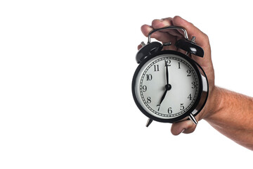 Black alarm clock in a man's hand isolated on white background.