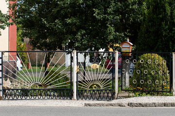 Metal fence in a village in Poland. Fencing