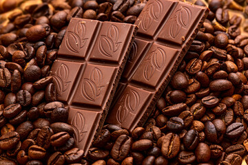 chocolate pieces and coffee beans background. sweet aroma dessert