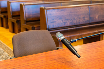 Closeup of microphone in the courthouse. Justice system, witness testimony. Nobody - obrazy, fototapety, plakaty
