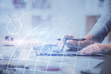 Double exposure of woman hands working on computer and world map hologram drawing. International...