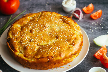 Chicken and potato pie. Tasty pie. Pie and vegetables on the table 