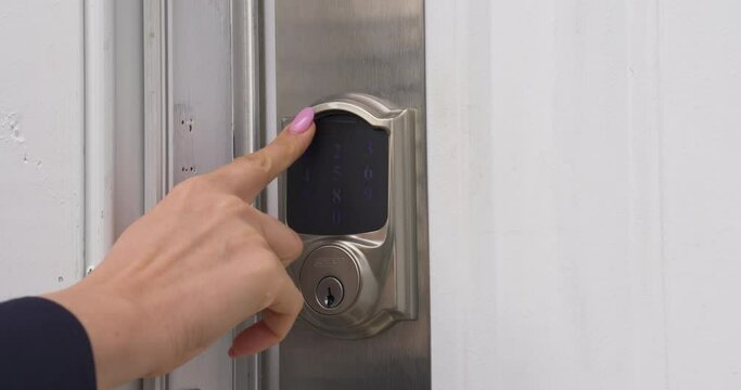 Close up of Female Hand Entering Security System Code