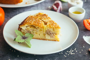 Chicken and potato pie. Tasty pie. Pie and vegetables on the table 