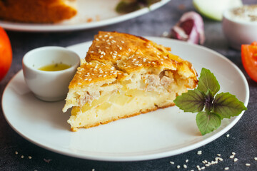 Chicken and potato pie. Tasty pie. Pie and vegetables on the table 