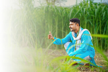 Naklejka na ściany i meble indian farmer at sugarcane field