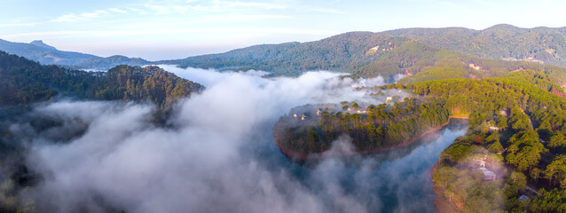 Panoramic view in early morning of an alpine lake near city of Dalat in Vietnam.