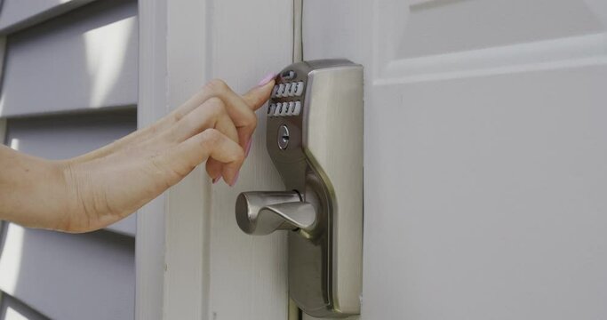 Close up of Female Hand Entering Security System Code