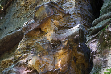 ancient rock face of the eroded sandstone in the mountains abstract background