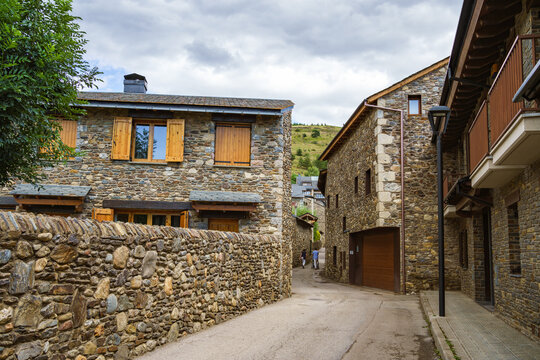 Picturesque street with buildings with stone walls in Llivia, Catalonia, Spain