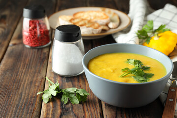 Concept of tasty food with pumpkin soup on wooden table